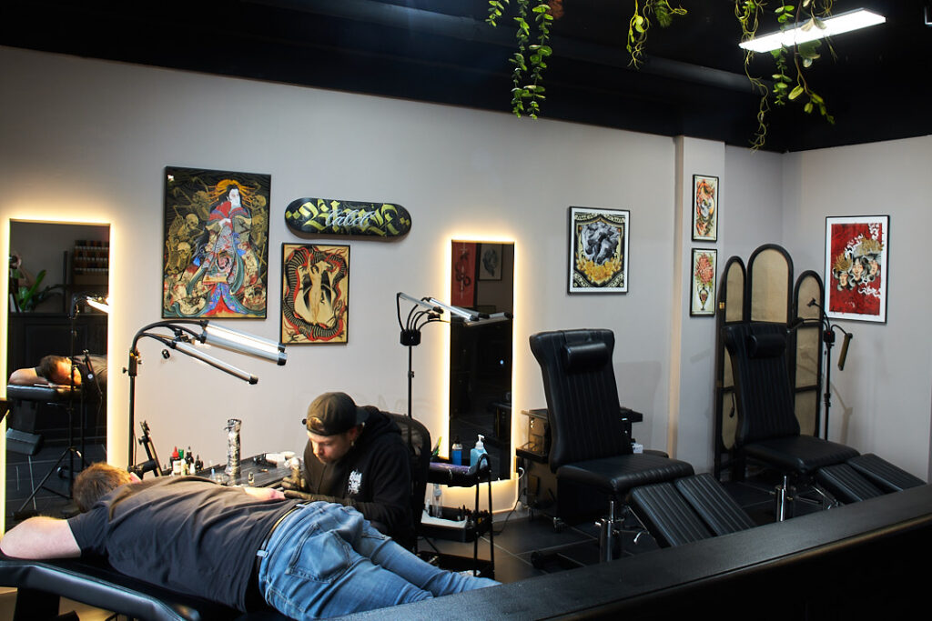 Tattoo artist working under a ring light, deep in concentration