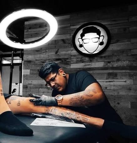 Two-chair tattoo studio with backlit mirrors and curated wall art